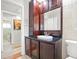 Bathroom with dark wood vanity, white countertop, and large mirror at 811 Woodley Rd, Clearwater, FL 33764