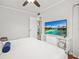 Bright bedroom featuring wood floors and a television at 811 Woodley Rd, Clearwater, FL 33764