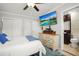 Bedroom with a flat screen television, ensuite bathroom, and three closets at 811 Woodley Rd, Clearwater, FL 33764