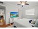 Cozy bedroom with a ceiling fan, TV, and neutral decor at 811 Woodley Rd, Clearwater, FL 33764
