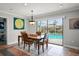 Cozy dining area with a wooden table, views of the pool, and ample natural light at 811 Woodley Rd, Clearwater, FL 33764