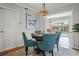 Cozy dining area featuring a chandelier and a view of the pool area, blending indoor/outdoor living at 811 Woodley Rd, Clearwater, FL 33764