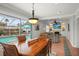 Dining room leading to the screened pool and living room, shows an open floor plan at 811 Woodley Rd, Clearwater, FL 33764