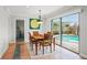 Cozy dining area with a wooden table, views of the pool, and ample natural light at 811 Woodley Rd, Clearwater, FL 33764
