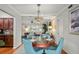 Inviting dining room featuring wood floors, round table with seating, and natural light at 811 Woodley Rd, Clearwater, FL 33764