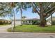 Inviting home showcasing a well-maintained lawn, mature trees, and a two-car garage at 811 Woodley Rd, Clearwater, FL 33764