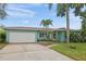Charming single-story home featuring a well-maintained lawn, and lush landscaping for enhanced curb appeal at 811 Woodley Rd, Clearwater, FL 33764