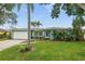 Charming single-story home with mature landscaping and a manicured front lawn at 811 Woodley Rd, Clearwater, FL 33764
