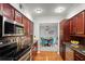 Modern kitchen with stainless steel appliances, granite countertops, and cherry wood cabinets at 811 Woodley Rd, Clearwater, FL 33764