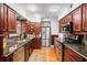 Modern kitchen featuring stainless steel appliances and cherry wood cabinetry at 811 Woodley Rd, Clearwater, FL 33764