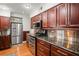 Modern kitchen featuring stainless steel appliances and cherry wood cabinetry at 811 Woodley Rd, Clearwater, FL 33764