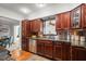 Cozy kitchen featuring stainless steel appliances, granite countertops, and cherry wood cabinetry at 811 Woodley Rd, Clearwater, FL 33764