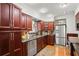 Modern kitchen featuring stainless steel appliances and cherry wood cabinetry at 811 Woodley Rd, Clearwater, FL 33764