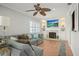 Comfortable living room with a ceiling fan, fireplace, built-in shelves, and a plush sectional sofa at 811 Woodley Rd, Clearwater, FL 33764