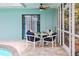Covered patio with table and chairs, perfect for outdoor dining next to the inviting pool at 811 Woodley Rd, Clearwater, FL 33764