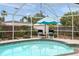 Beautiful pool area with tiled deck, privacy fence and a nice shaded seating area at 811 Woodley Rd, Clearwater, FL 33764