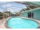 Relaxing screened-in pool area surrounded by lush greenery, perfect for outdoor enjoyment and privacy at 811 Woodley Rd, Clearwater, FL 33764