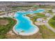 Wide aerial view of the lagoon amenities and surrounding community at 8891 Bower Bass Cir, Wesley Chapel, FL 33545