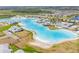 Stunning aerial view of the community's resort-style lagoon and amenities at 8891 Bower Bass Cir, Wesley Chapel, FL 33545