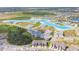 An aerial shot showcases a neighborhood with modern homes surrounding a crystal-clear lagoon, highlighting community living at 8891 Bower Bass Cir, Wesley Chapel, FL 33545