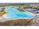 Expansive aerial view of the community lagoon, offering a resort-like experience at 8891 Bower Bass Cir, Wesley Chapel, FL 33545
