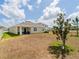 Backyard featuring a lawn, a house with awning, and a tree at 8891 Bower Bass Cir, Wesley Chapel, FL 33545
