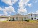 Backyard featuring a lawn, a house with awning, and a soccer goal at 8891 Bower Bass Cir, Wesley Chapel, FL 33545