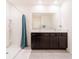 Bathroom featuring a shower with curtain and a double sink vanity with dark cabinets at 8891 Bower Bass Cir, Wesley Chapel, FL 33545