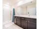 Bright bathroom with double sinks, shower, and large mirror at 8891 Bower Bass Cir, Wesley Chapel, FL 33545