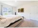 Bedroom with a large window for natural light and a mounted television at 8891 Bower Bass Cir, Wesley Chapel, FL 33545