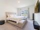 Cozy bedroom featuring a large window for natural light and comfortable furnishings at 8891 Bower Bass Cir, Wesley Chapel, FL 33545