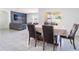 Open-concept dining area with modern tile flooring, connecting to a living room and offering great natural light at 8891 Bower Bass Cir, Wesley Chapel, FL 33545
