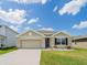 Lovely single-Gathering home with a two-car garage, neutral-colored exterior, and well-maintained landscaping at 8891 Bower Bass Cir, Wesley Chapel, FL 33545