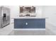 Spacious kitchen island featuring granite countertops, stainless steel refrigerator, and ample storage space at 8891 Bower Bass Cir, Wesley Chapel, FL 33545