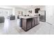 Bright kitchen featuring an island, stainless steel appliances and dining area at 8891 Bower Bass Cir, Wesley Chapel, FL 33545