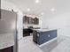 Well-equipped kitchen with granite countertops, stainless steel appliances, and dark wood cabinets and an island with sink at 8891 Bower Bass Cir, Wesley Chapel, FL 33545