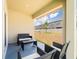 Relaxing covered patio features comfortable outdoor seating and views of the backyard at 8891 Bower Bass Cir, Wesley Chapel, FL 33545