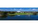 Beautiful aerial view of golf course and a lakeside property with lush greenery and a calming lake at 9346 Southern Belle Dr, Weeki Wachee, FL 34613