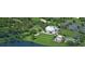Aerial shot highlights golf course, pool, and extensive parking for clubhouse amenities amidst green landscape at 9346 Southern Belle Dr, Weeki Wachee, FL 34613