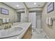 Neutral bathroom with white marble floors, shower with glass door, and white towels at 9346 Southern Belle Dr, Weeki Wachee, FL 34613