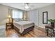 Bedroom with a queen bed, side tables with lamps, ceiling fan, and wood-look floors at 9346 Southern Belle Dr, Weeki Wachee, FL 34613
