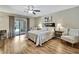 Bright bedroom with sliding glass doors to a patio, wood-look floors, and ceiling fan at 9346 Southern Belle Dr, Weeki Wachee, FL 34613