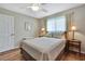Bedroom with a queen bed, side tables with lamps, ceiling fan, and wood-look floors at 9346 Southern Belle Dr, Weeki Wachee, FL 34613