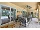 Outdoor patio with ceiling fan and sliding glass doors overlooking the pool at 9346 Southern Belle Dr, Weeki Wachee, FL 34613