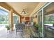 Inviting covered patio with stylish furniture, ceiling fan, and views of the backyard and pool at 9346 Southern Belle Dr, Weeki Wachee, FL 34613