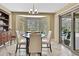 Dining area with a table, seating, a bay window with a view of the pool, and sliding glass door at 9346 Southern Belle Dr, Weeki Wachee, FL 34613