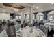 Well-appointed dining room with chandelier, neutral color palette, and tables set for elegant dining at 9346 Southern Belle Dr, Weeki Wachee, FL 34613