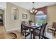 Elegant dining room featuring a decorative chandelier and views of the outdoors at 9346 Southern Belle Dr, Weeki Wachee, FL 34613