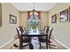 Elegant dining room featuring a decorative chandelier and views of the outdoors at 9346 Southern Belle Dr, Weeki Wachee, FL 34613