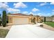 Exterior of home featuring a pristine driveway and well-kept lawn, showcasing its curb appeal at 9346 Southern Belle Dr, Weeki Wachee, FL 34613